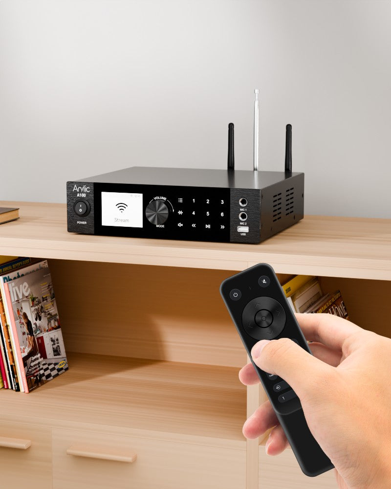 Arylic A100 100W stereo FM power amplifier in home listening room driving passive HiFi speakers