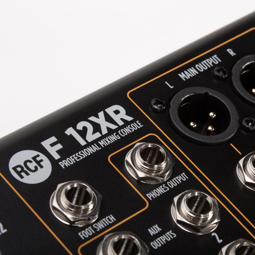 Close-up of RCF F12XR professional mixing console with various connectors and labels.