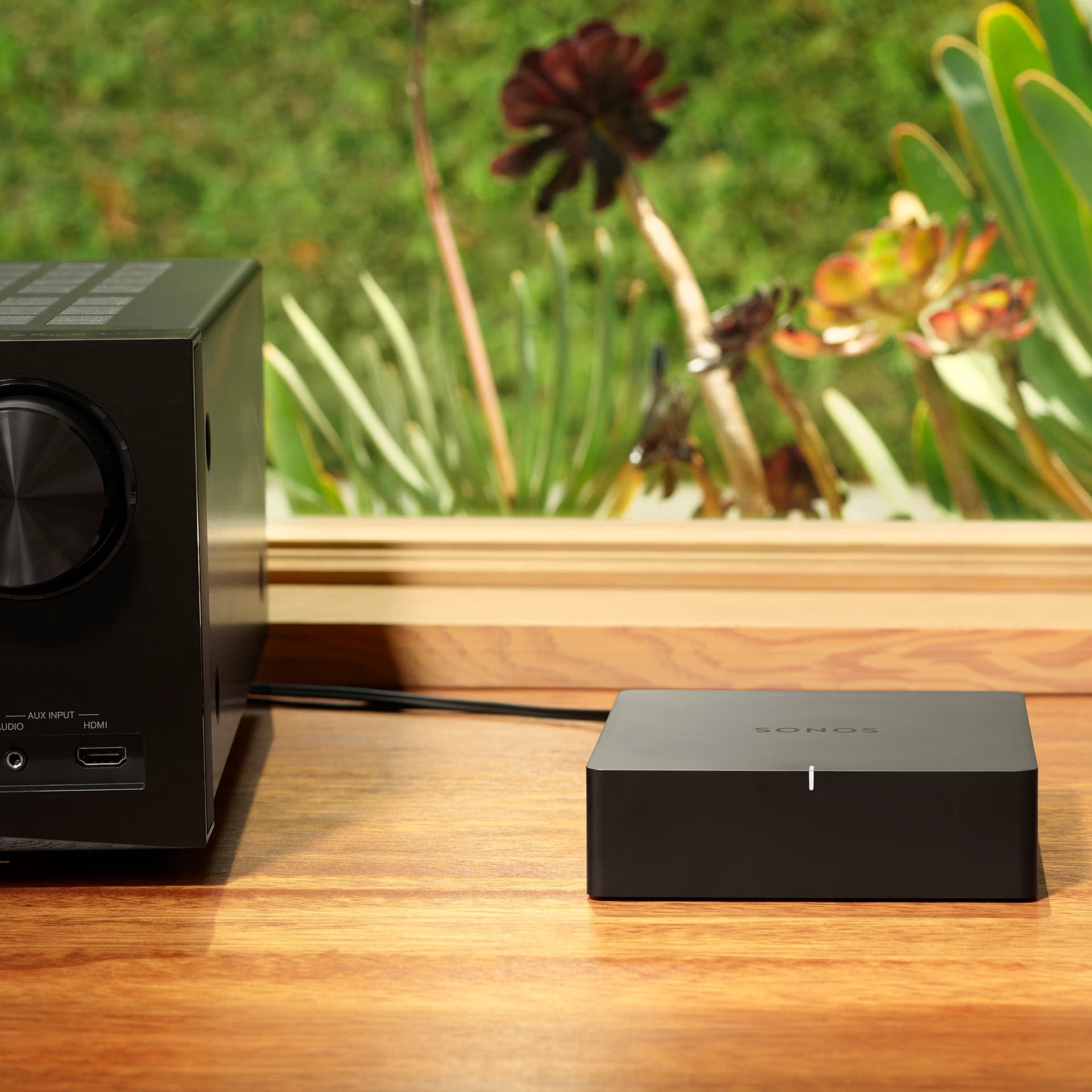 Sonos Port black connected to vintage hi-fi stereo amplifier adding wireless streaming capability