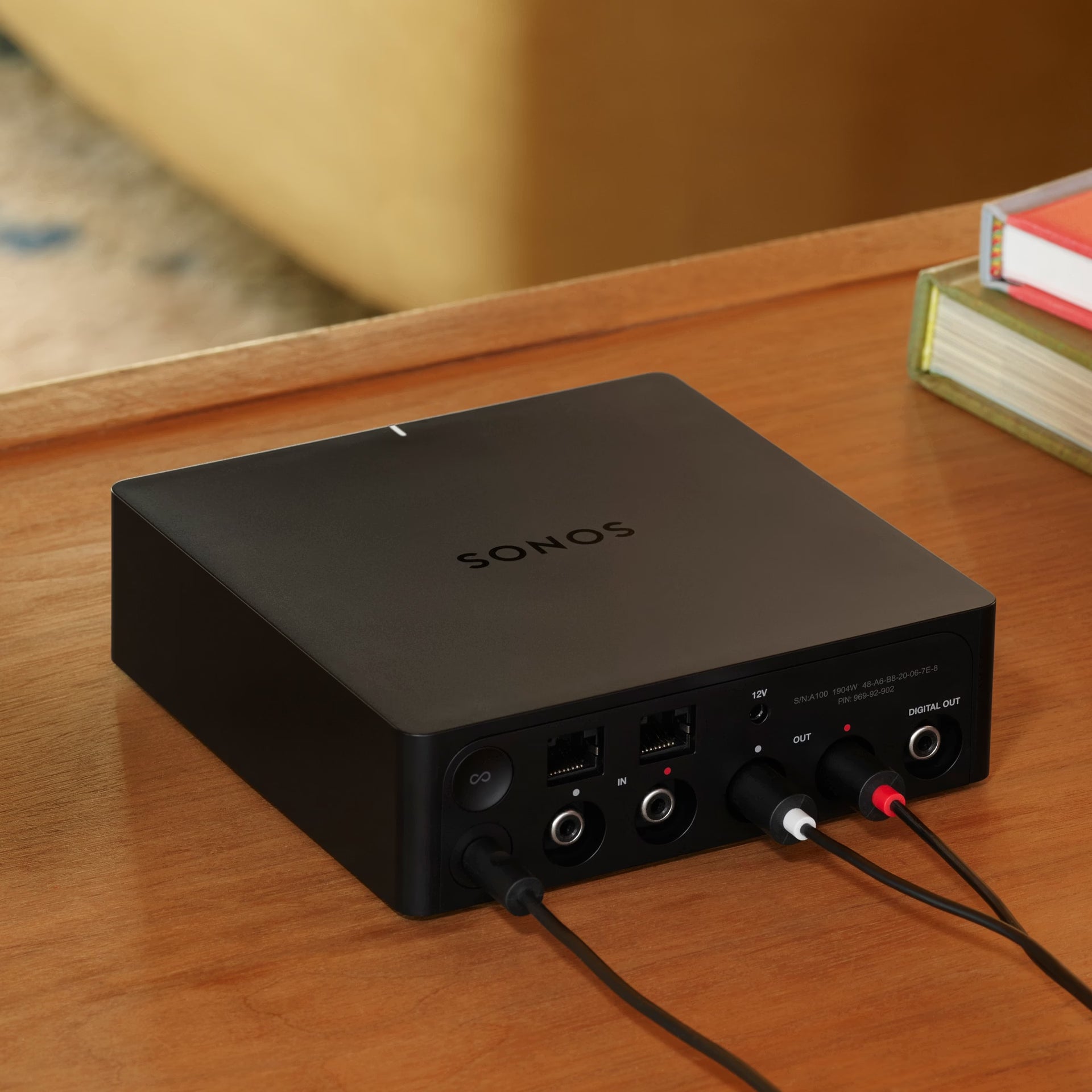 Sonos Port black connected to vintage hi-fi stereo amplifier adding wireless streaming capability