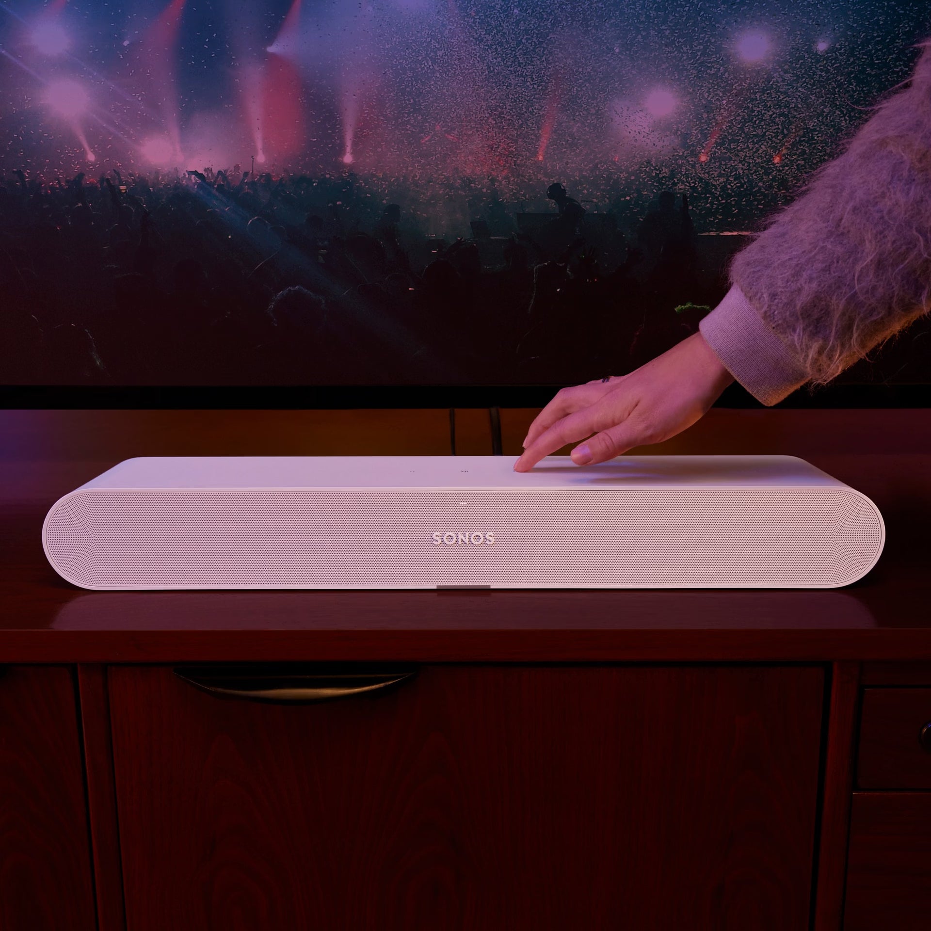 Sonos Ray Fury White soundbar below wall-mounted TV in bright modern living room — smart audio setup
