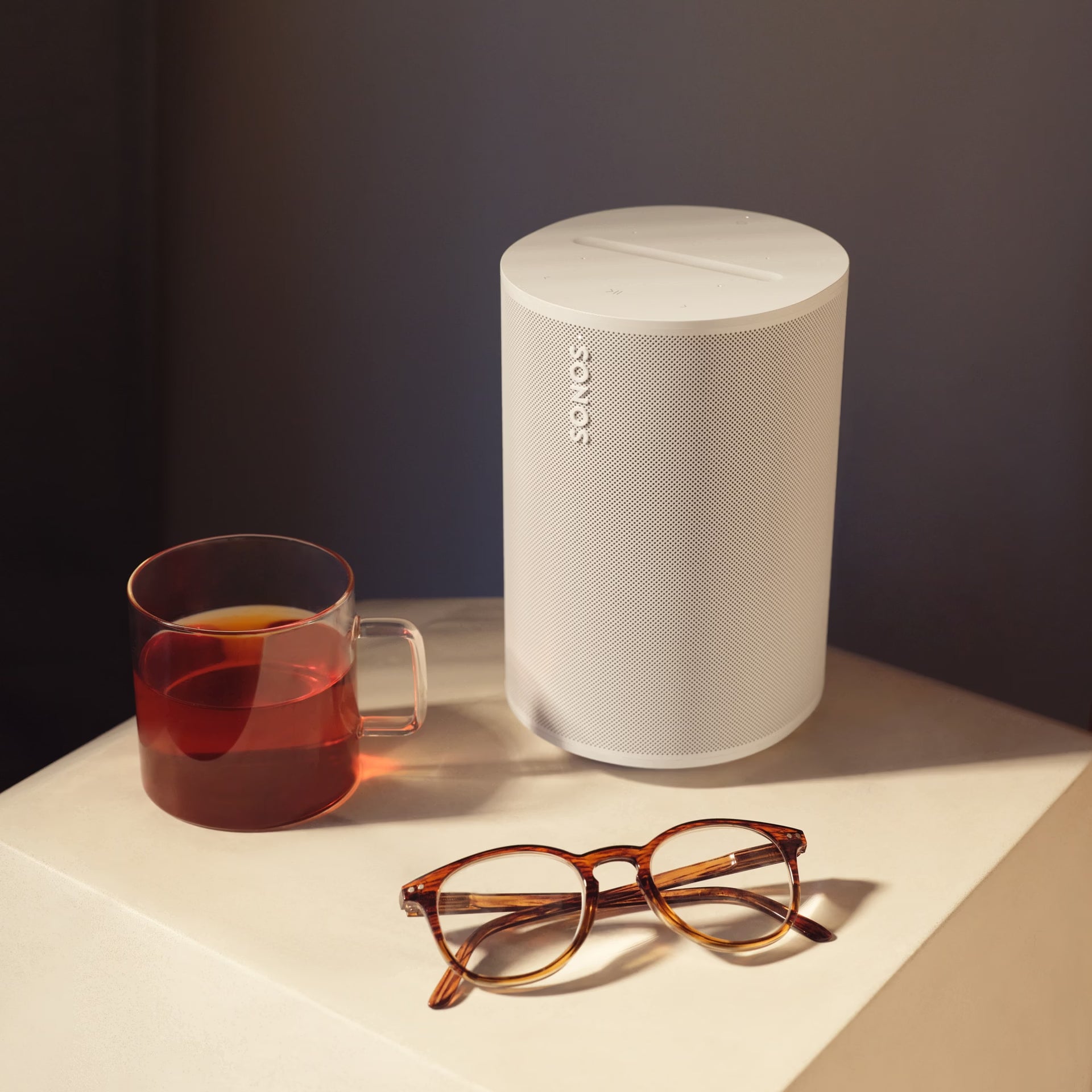 Sonos Era 100 White on a bright living room shelf delivering rich HiFi sound at home
