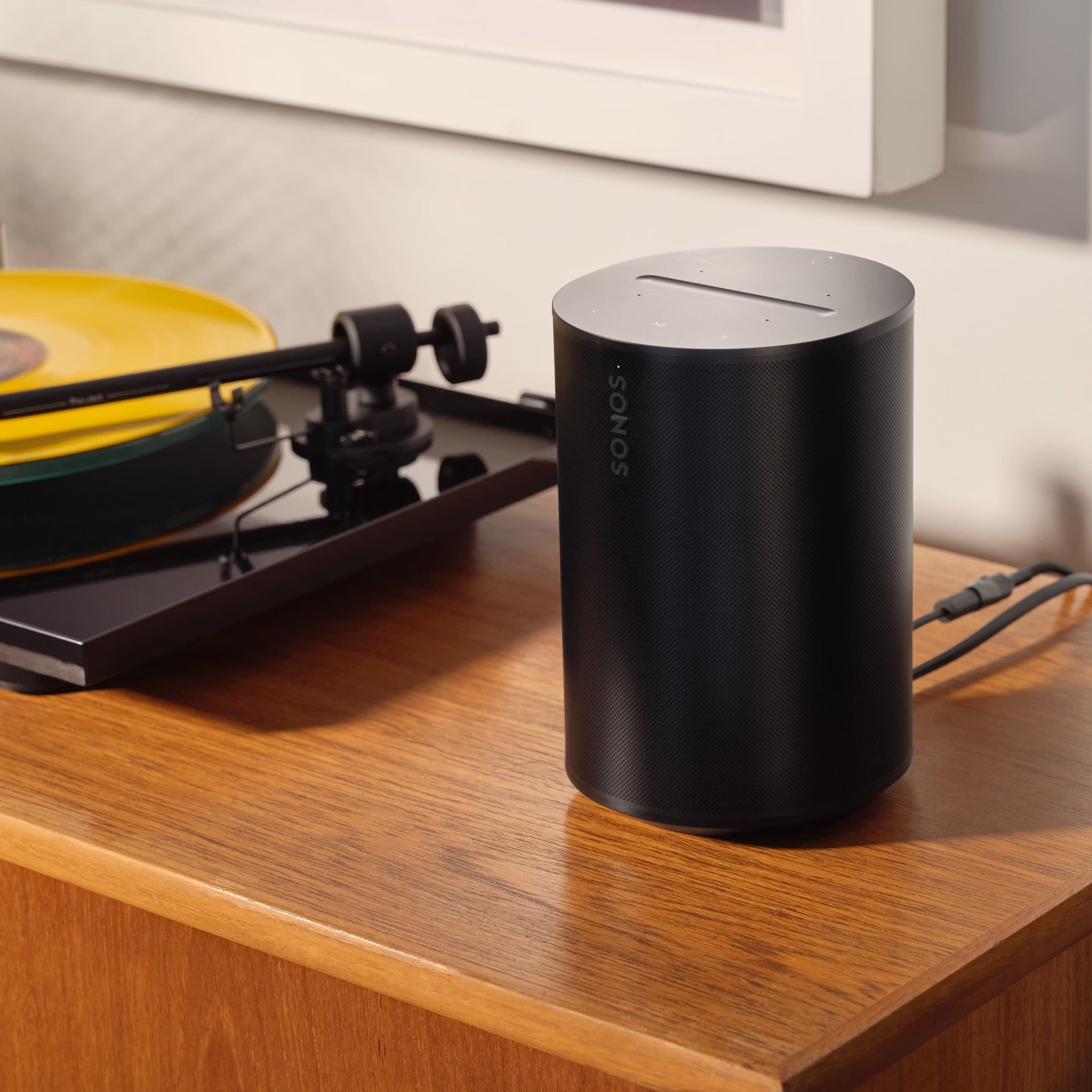 Sonos Era 100 Black smart speaker on a tidy desk enhancing home office audio quality