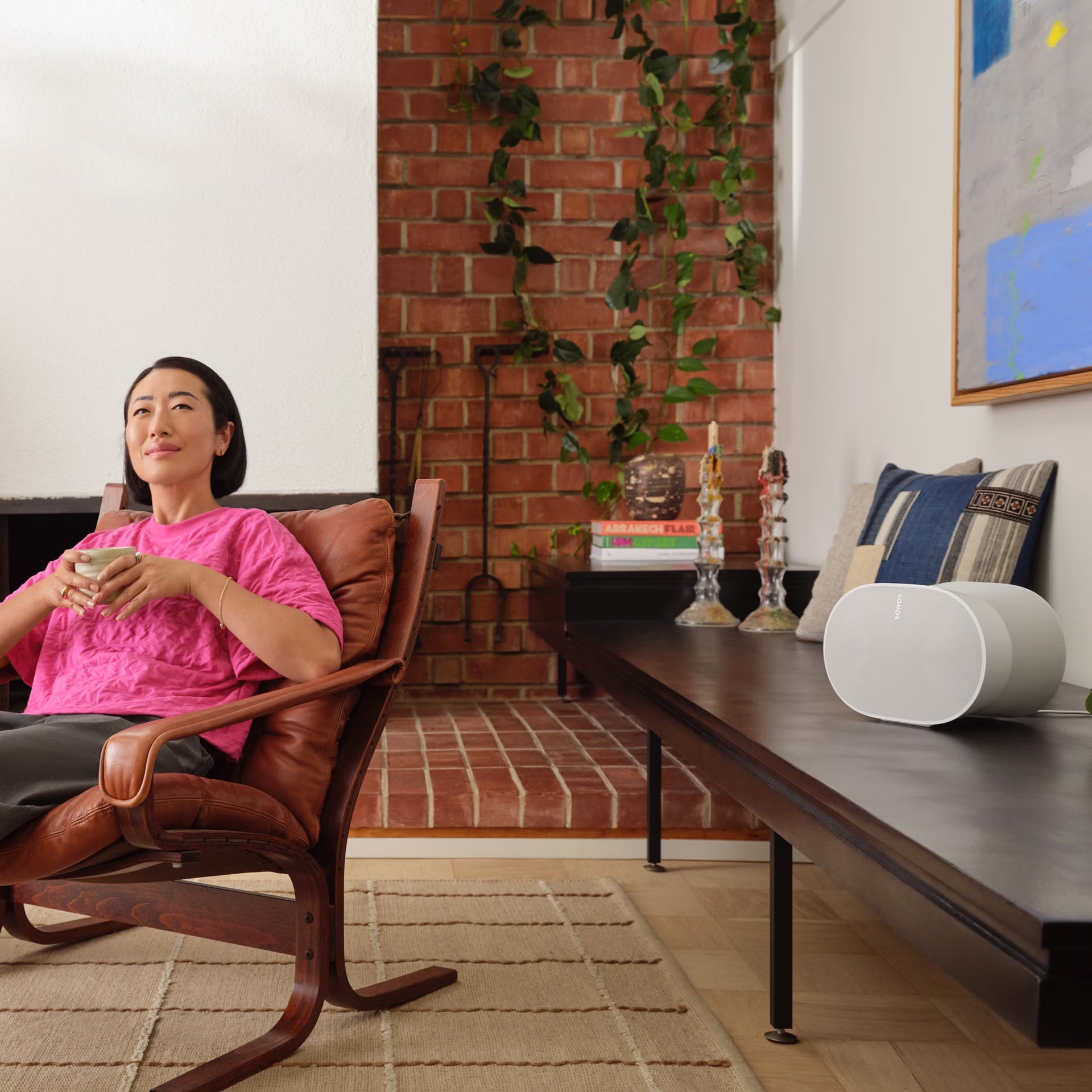 Sonos Era 300 white on sideboard in bright living room filling space with spatial Atmos sound