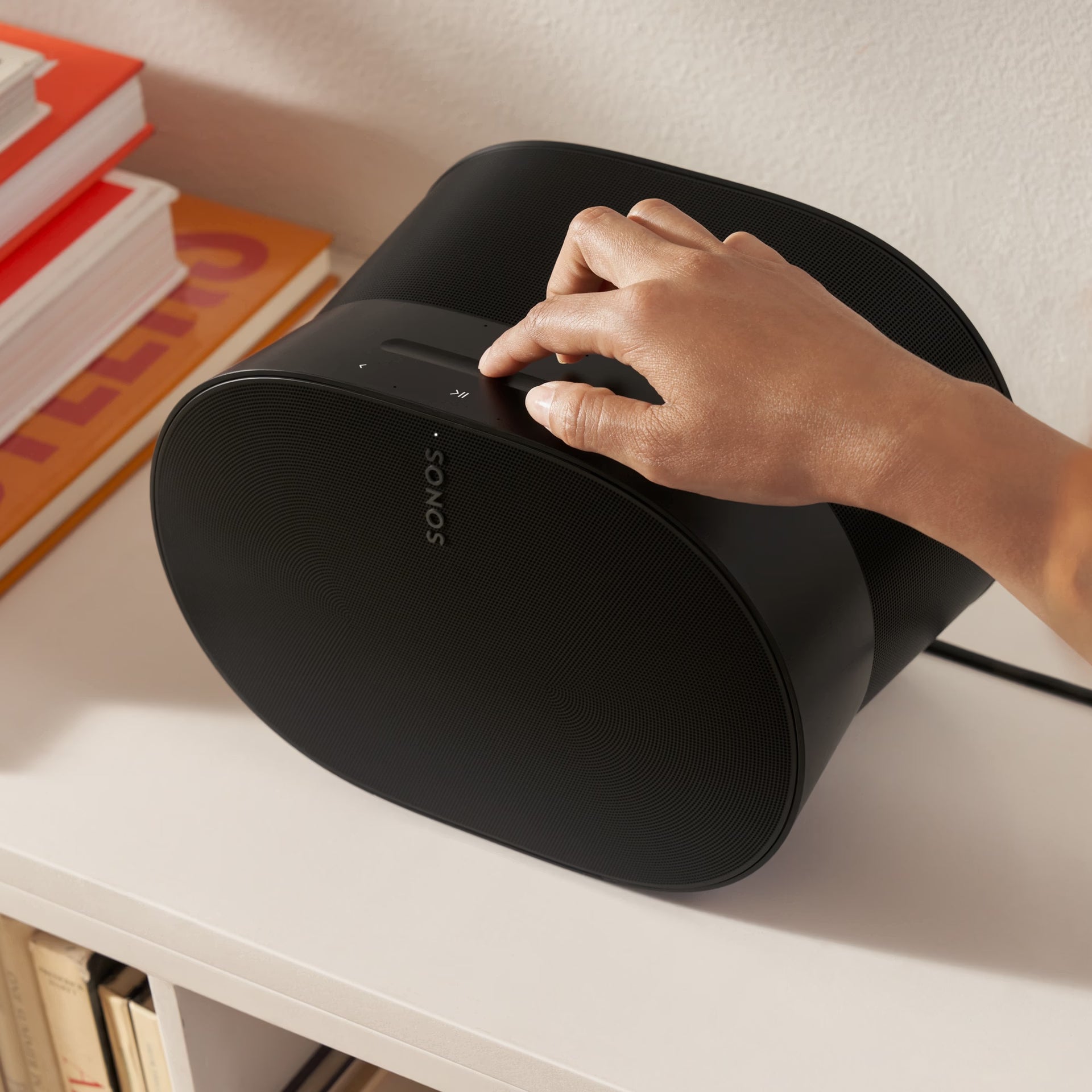 Sonos Era 300 black on sideboard in modern living room filling space with spatial Atmos sound