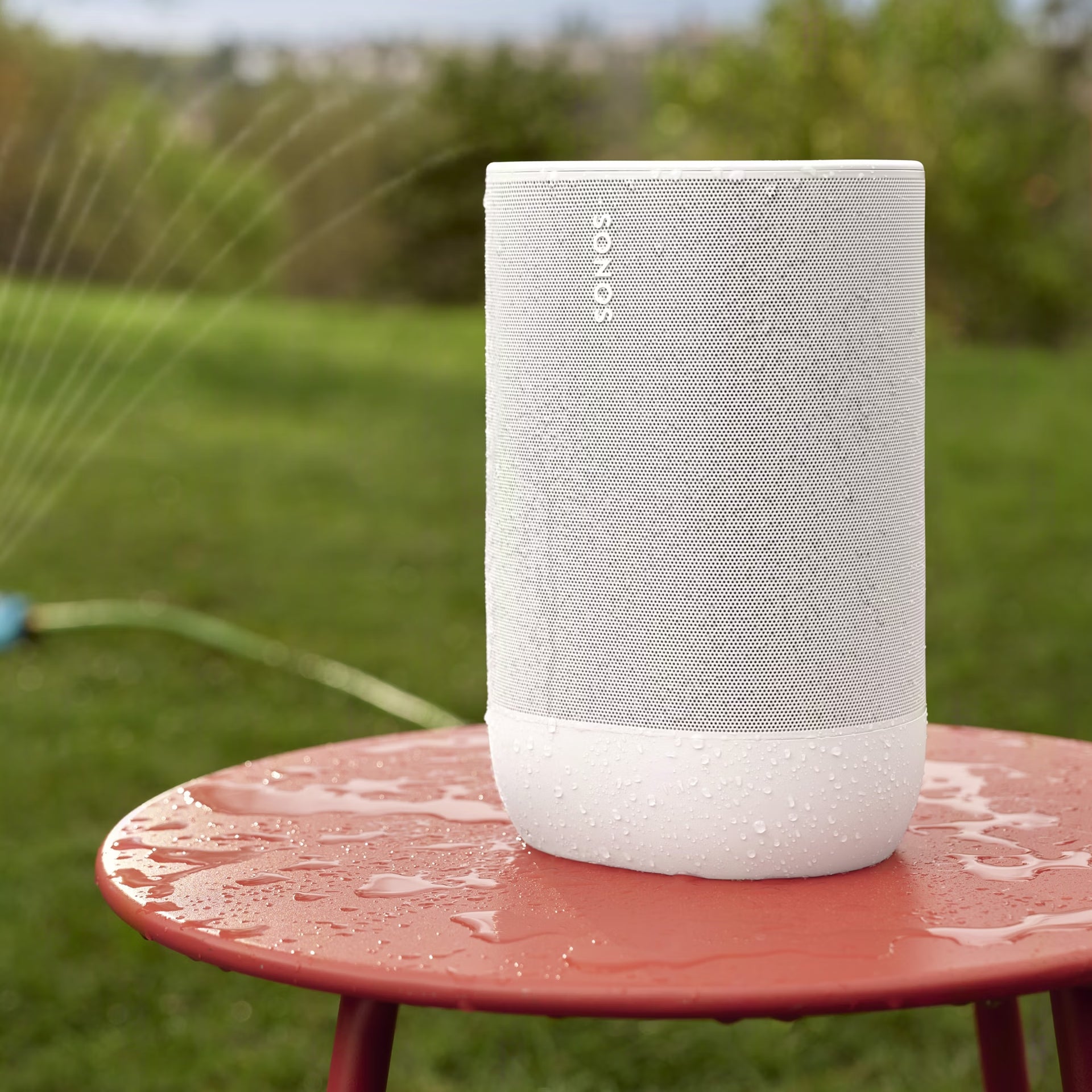 Sonos Move 2 White portable HiFi loudspeaker at a bright coastal picnic spot outdoors