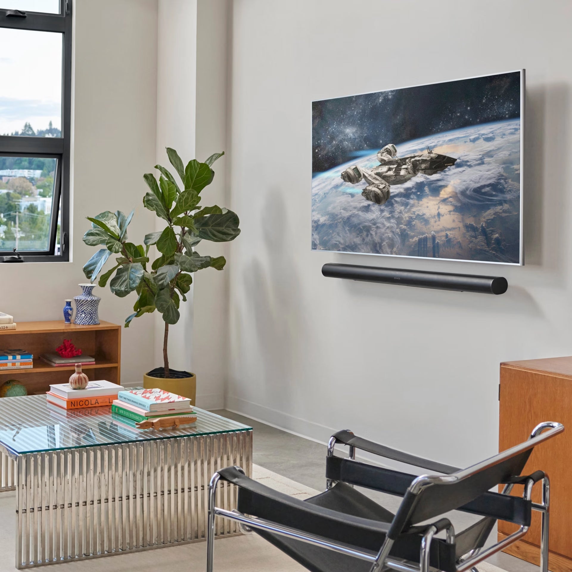 Sonos Arc Ultra black below large wall-mounted TV — flagship smart soundbar for home cinema audio
