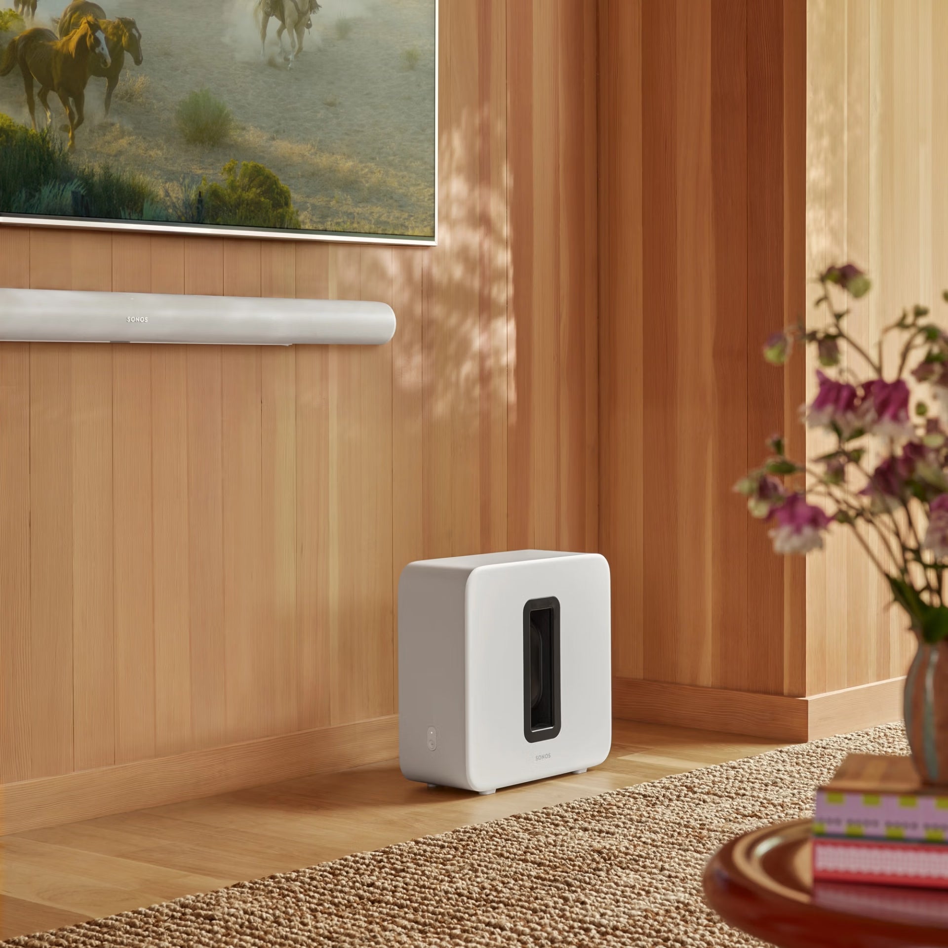 Family experiencing Sonos Sub 4 white in modern living room — immersive HiFi surround sound subwoofer