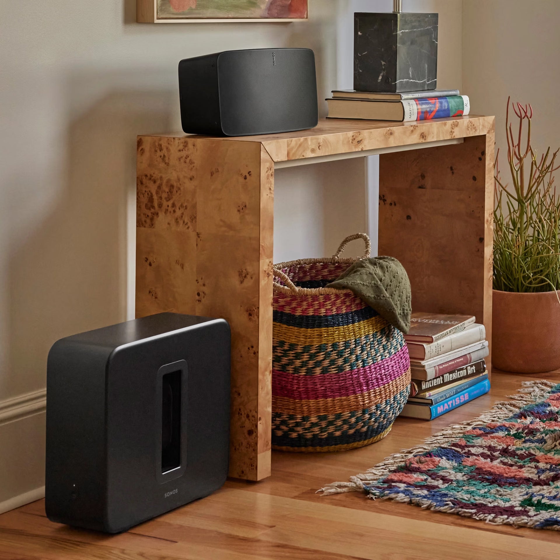 Sonos Sub 4 black beside TV unit in home theatre setup — powerful wireless subwoofer for deep bass