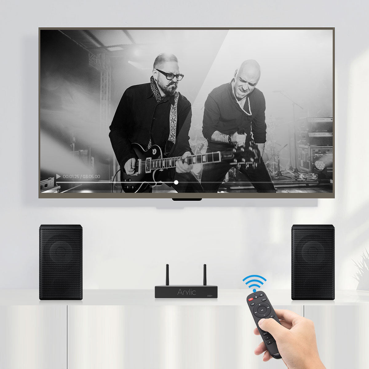 Arylic A30+ WiFi mini stereo amplifier on desk shelf powering bookshelf speakers in small room