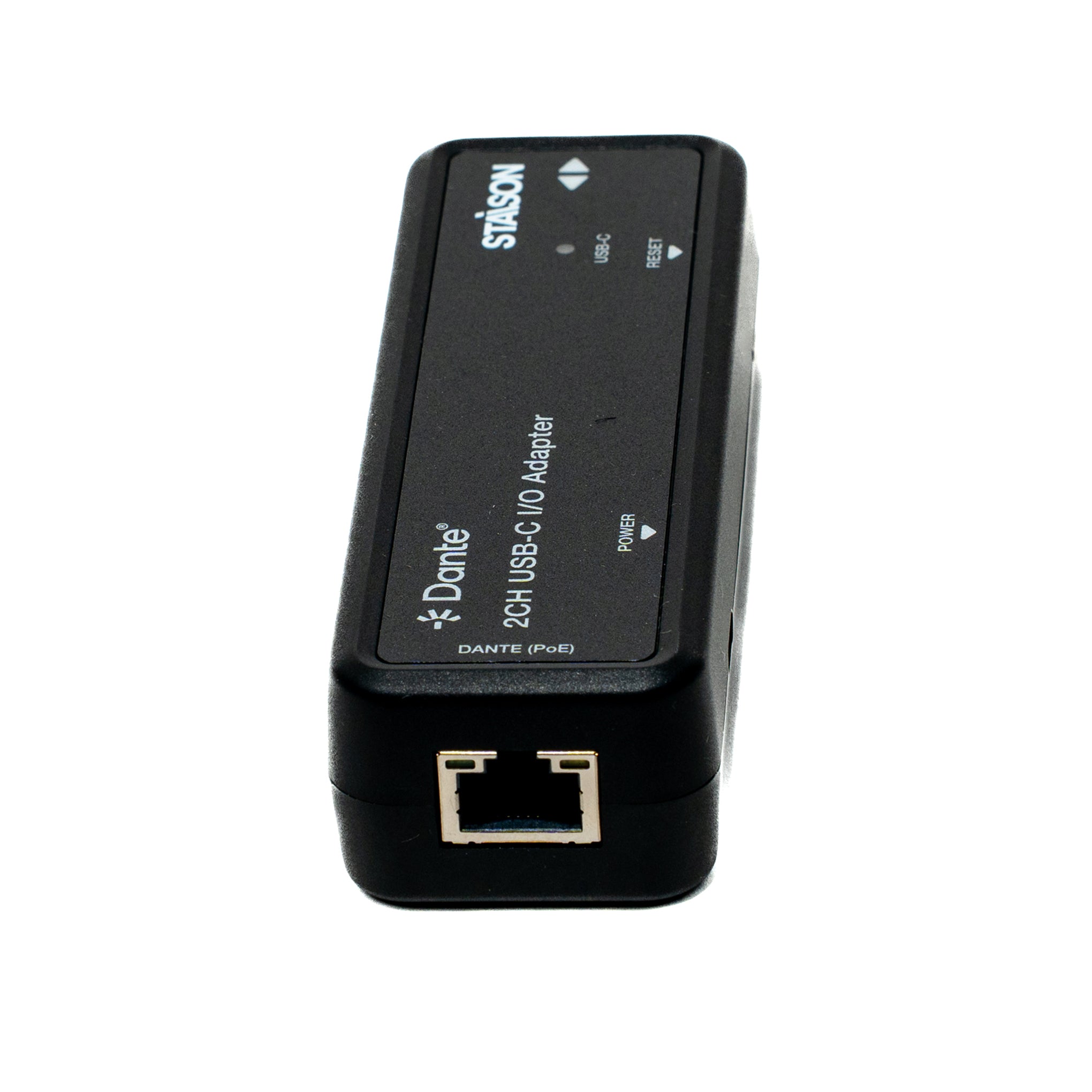 Black I/O adapter with Dante and Stasjon branding on a white background