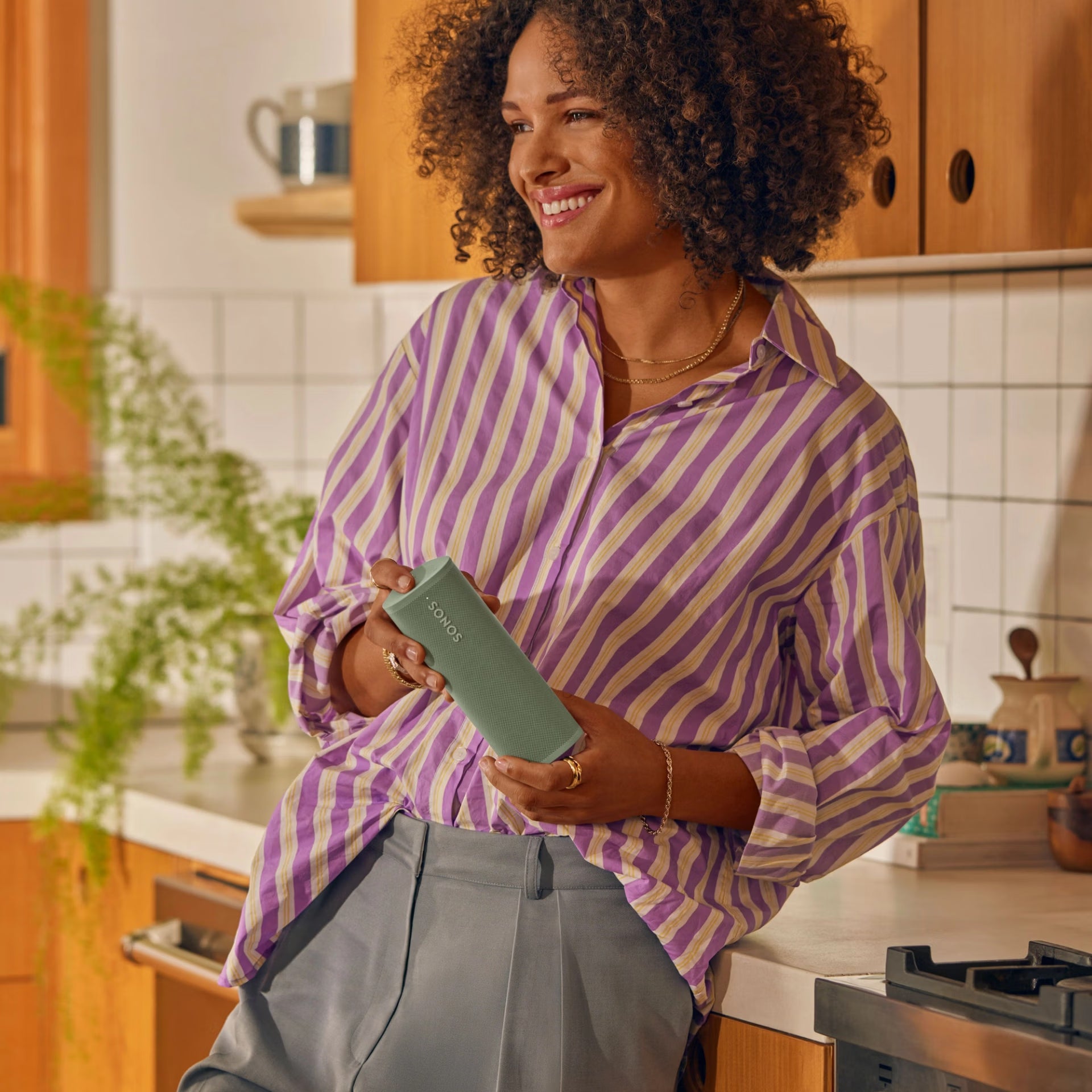 Sonos Roam 2 Green voice-enabled smart speaker on a shelf streaming music at home