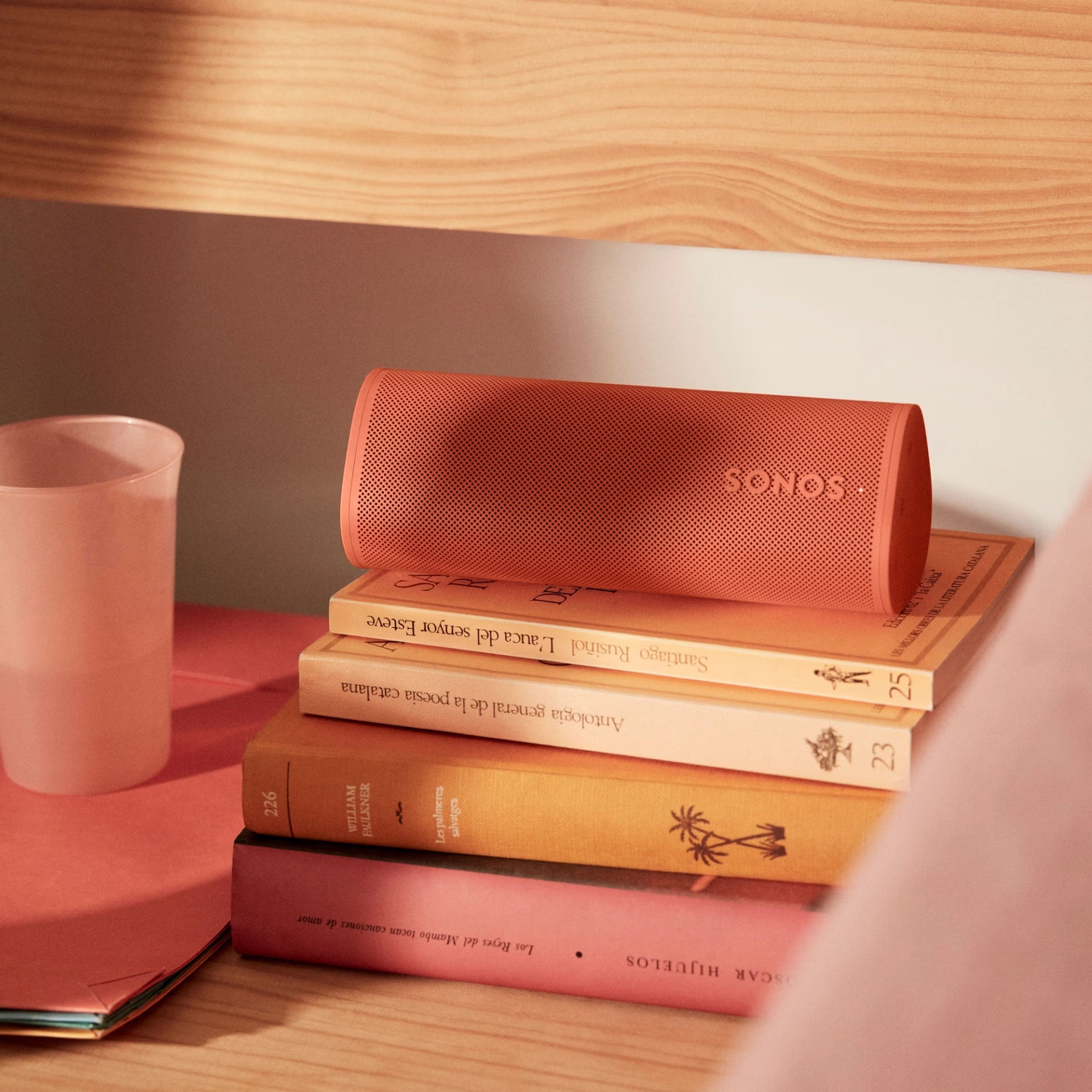 Sonos Roam 2 Red voice-enabled smart speaker on a desk streaming music at home