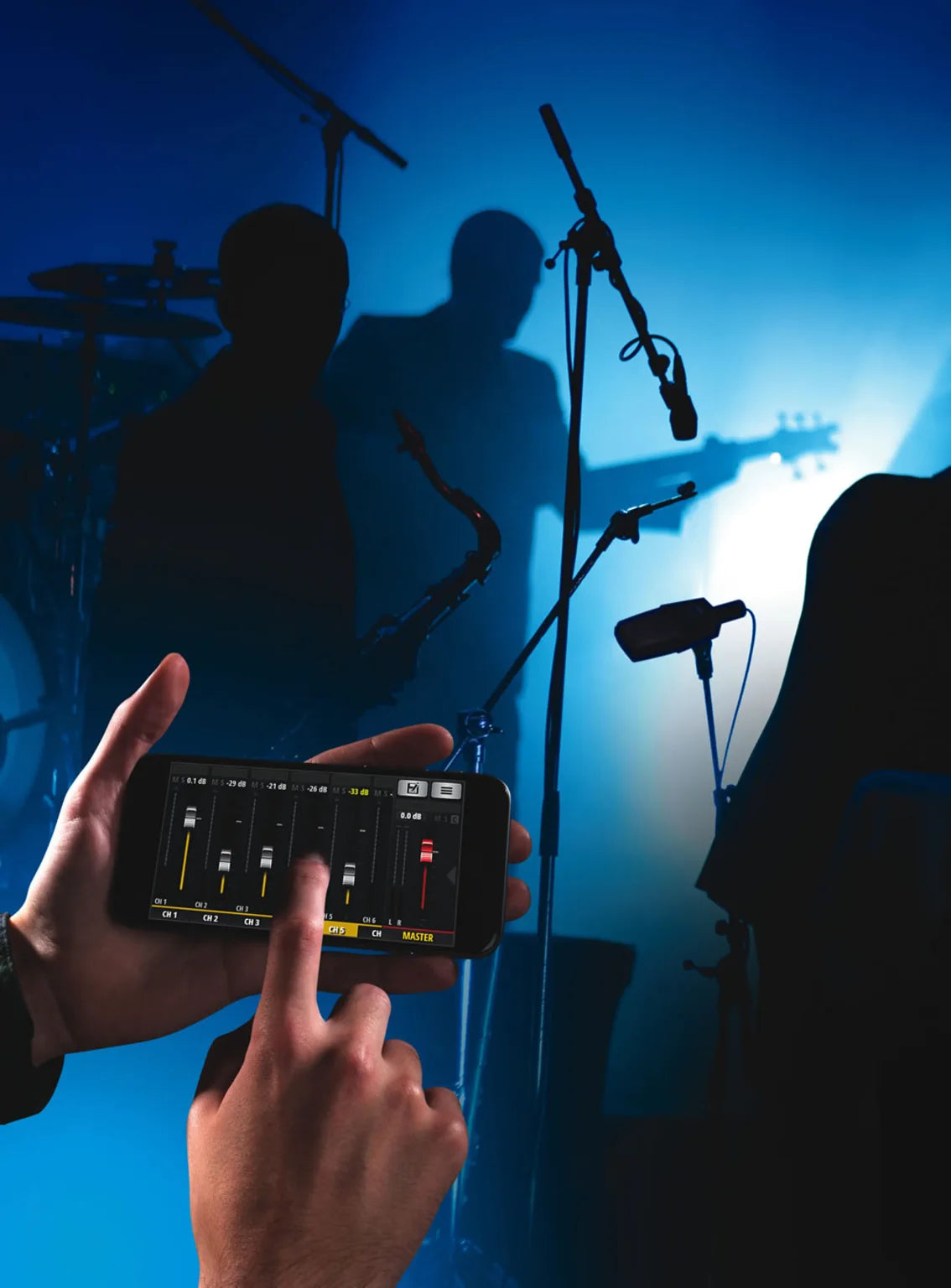 digital mixer interface on a mobile and music band performance on background 